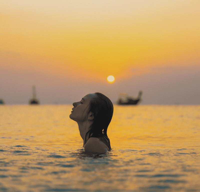 Swimming off a private charter boat at sunset in phuket