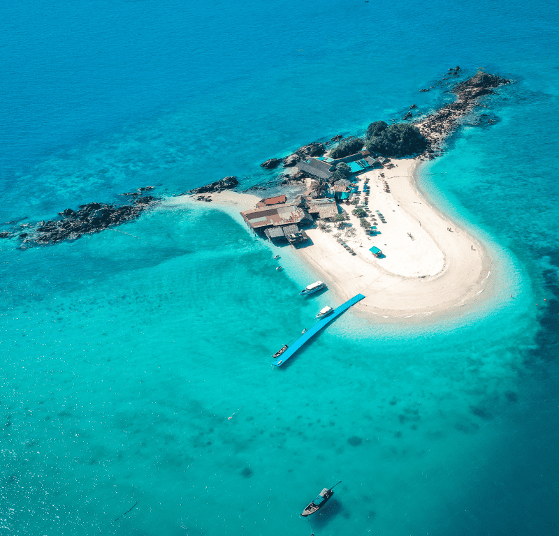 Drone shot from above overlooking the amazing khai island nai island and the clear waters surrounding it.