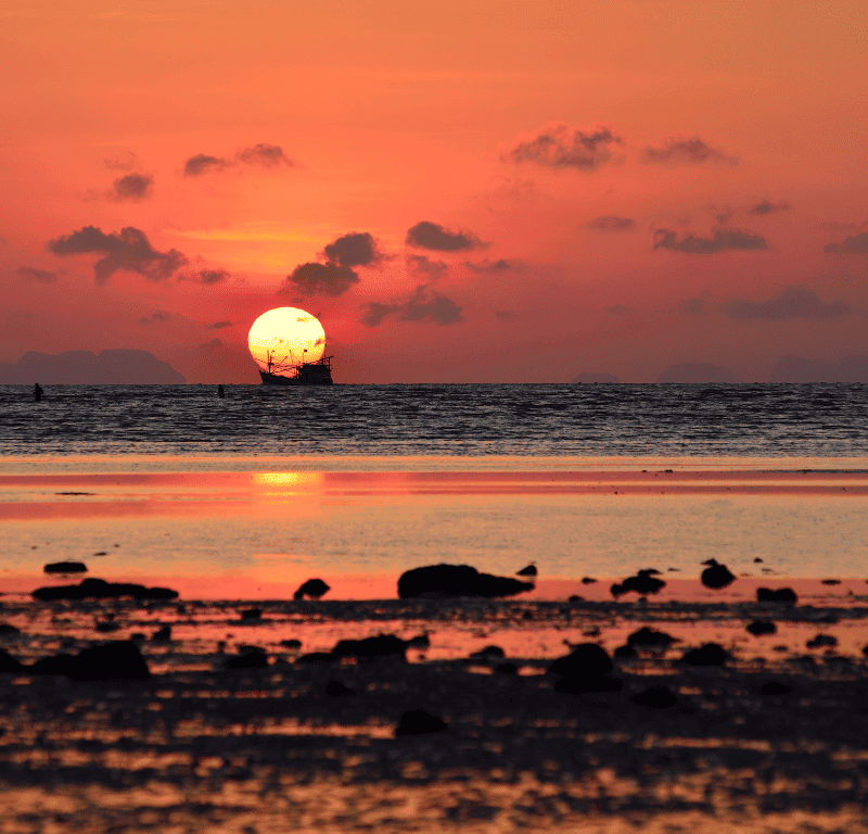 Breathtaking Sunrise Phuket Viewpoints 2025 Phuket sunrise golden rocky beach reflection.