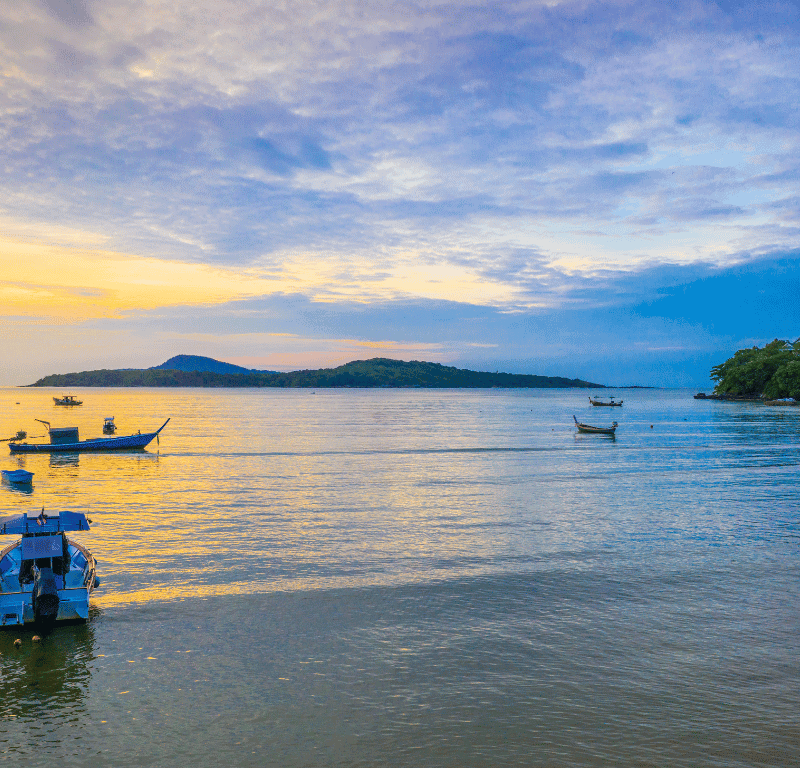 Breathtaking Sunrise Phuket Viewpoints 2025 Sunrise view with a few fishing boats on mooring.